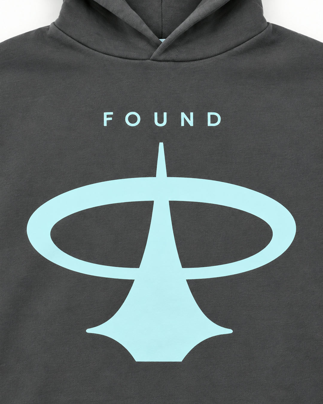 Close-up of the FOUND wordmark and pale-aqua emblem on the Ash hoodie