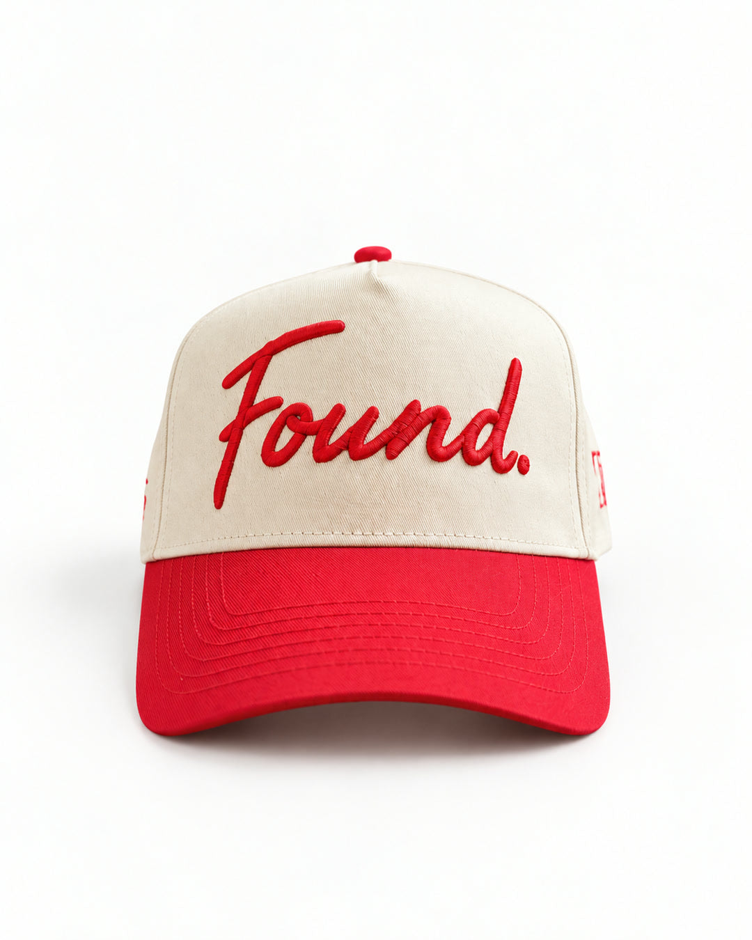 Found Cap in cream with red bill, front view with raised red Found. script